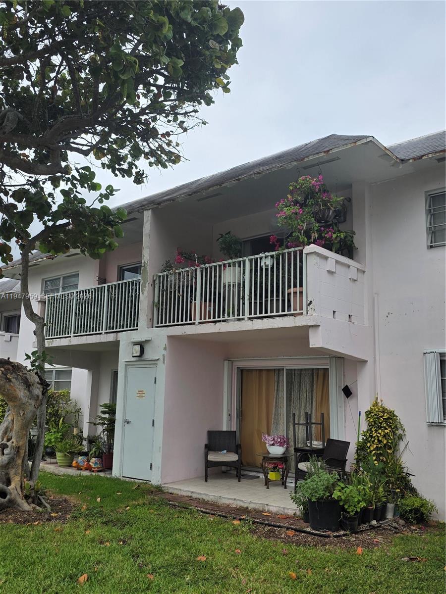 7424 Southwest 82nd Street, Unit D215 Miami, FL 33143 - Photo 28 of 33 a front view of a house with a garden