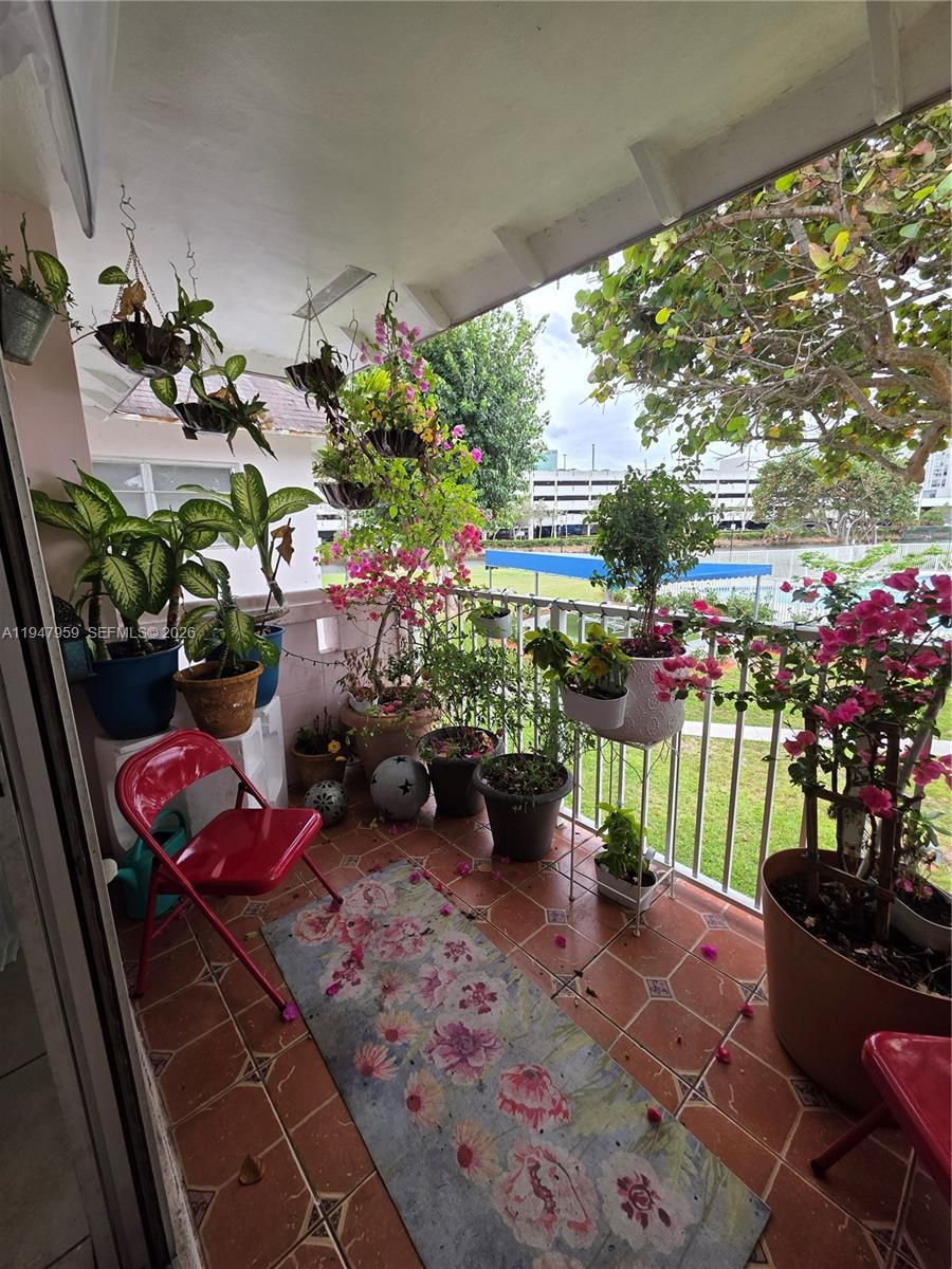 7424 Southwest 82nd Street, Unit D215 Miami, FL 33143 - Photo 4 of 33 a view of a room with lots of potted plants