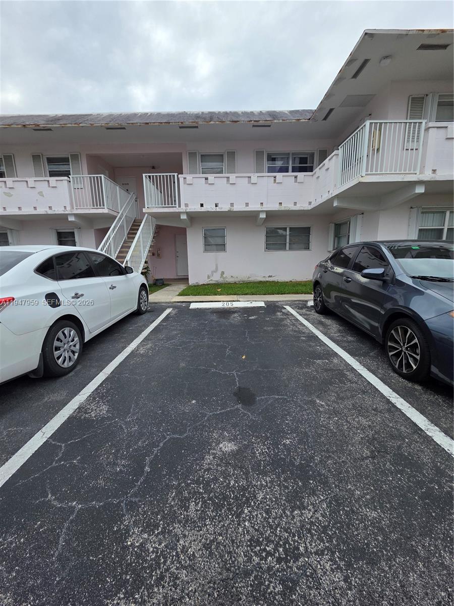 7424 Southwest 82nd Street, Unit D215 Miami, FL 33143 - Photo 7 of 33 a car parked in front of a building