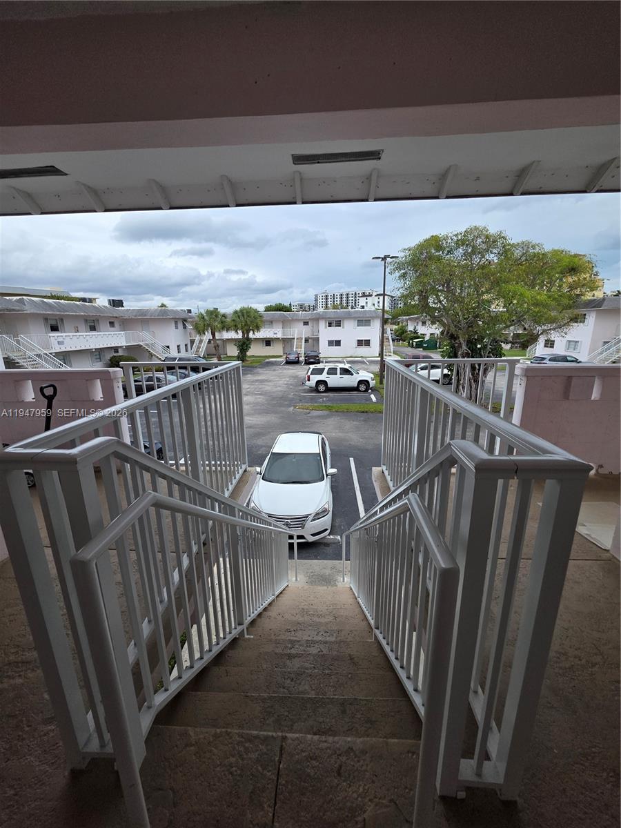 7424 Southwest 82nd Street, Unit D215 Miami, FL 33143 - Photo 8 of 33 a view of a balcony with wooden floor