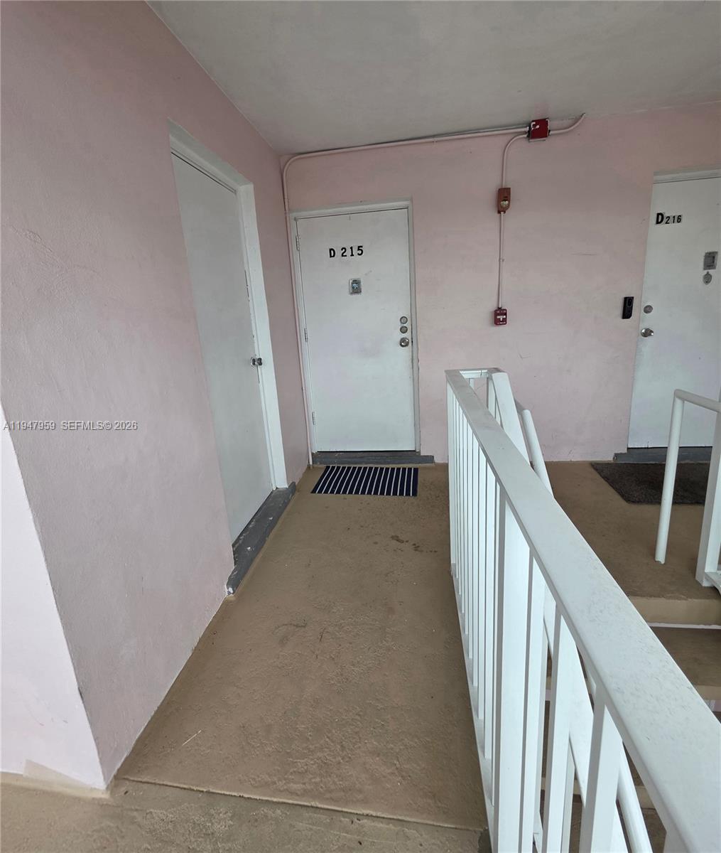 7424 Southwest 82nd Street, Unit D215 Miami, FL 33143 - Photo 10 of 33 a view of a hallway with wooden floor and staircase