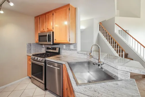 a kitchen with a sink stove top oven and microwave