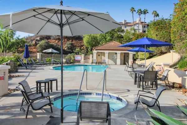 a view of a patio with chairs under an umbrella