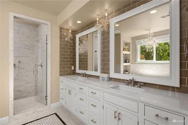 a bathroom with a granite countertop sink a toilet a mirror and shower