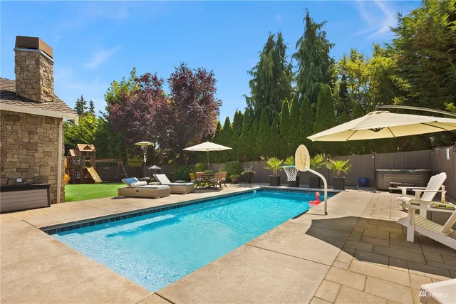 a view of a backyard with sitting area