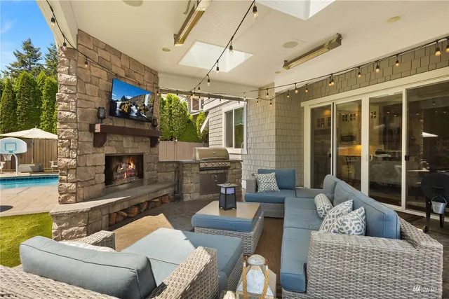a living room with furniture a large window and gym equipment