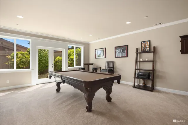 a living room with furniture and a painting on the wall