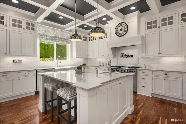 a large white kitchen with a large window