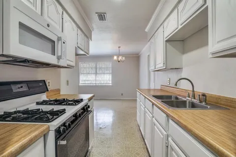 a kitchen that has a sink and a stove
