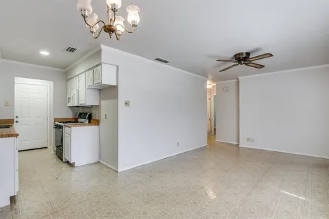 a view of kitchen with cabinets and window