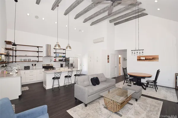 a living room with lots of furniture and kitchen view