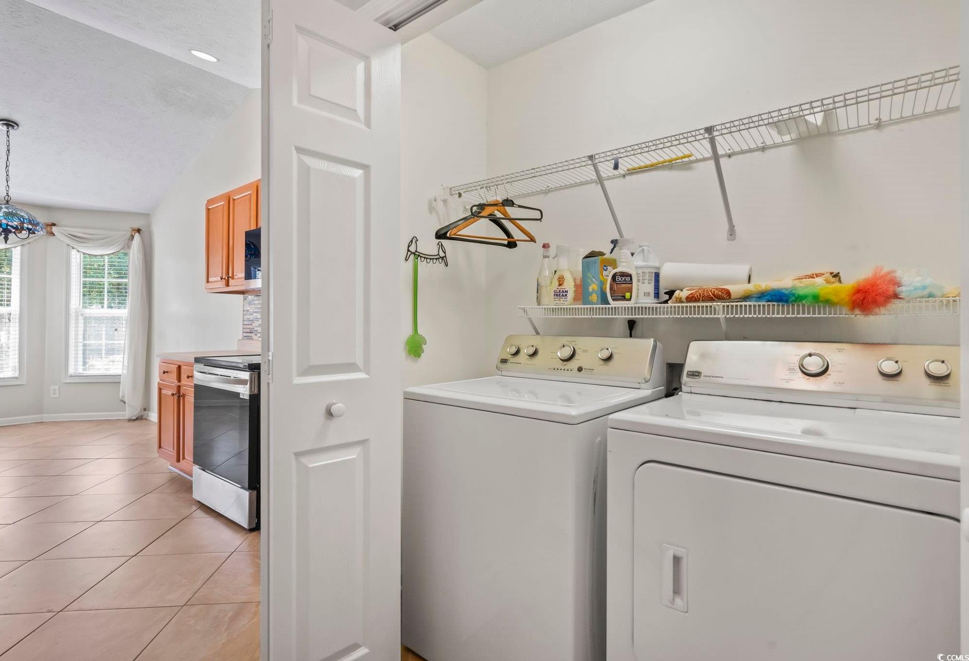 717 West Perry Road Myrtle Beach, SC 29579 - Photo 11 of 29 Laundry area with light tile patterned flooring, washer and dryer, and a textured ceiling