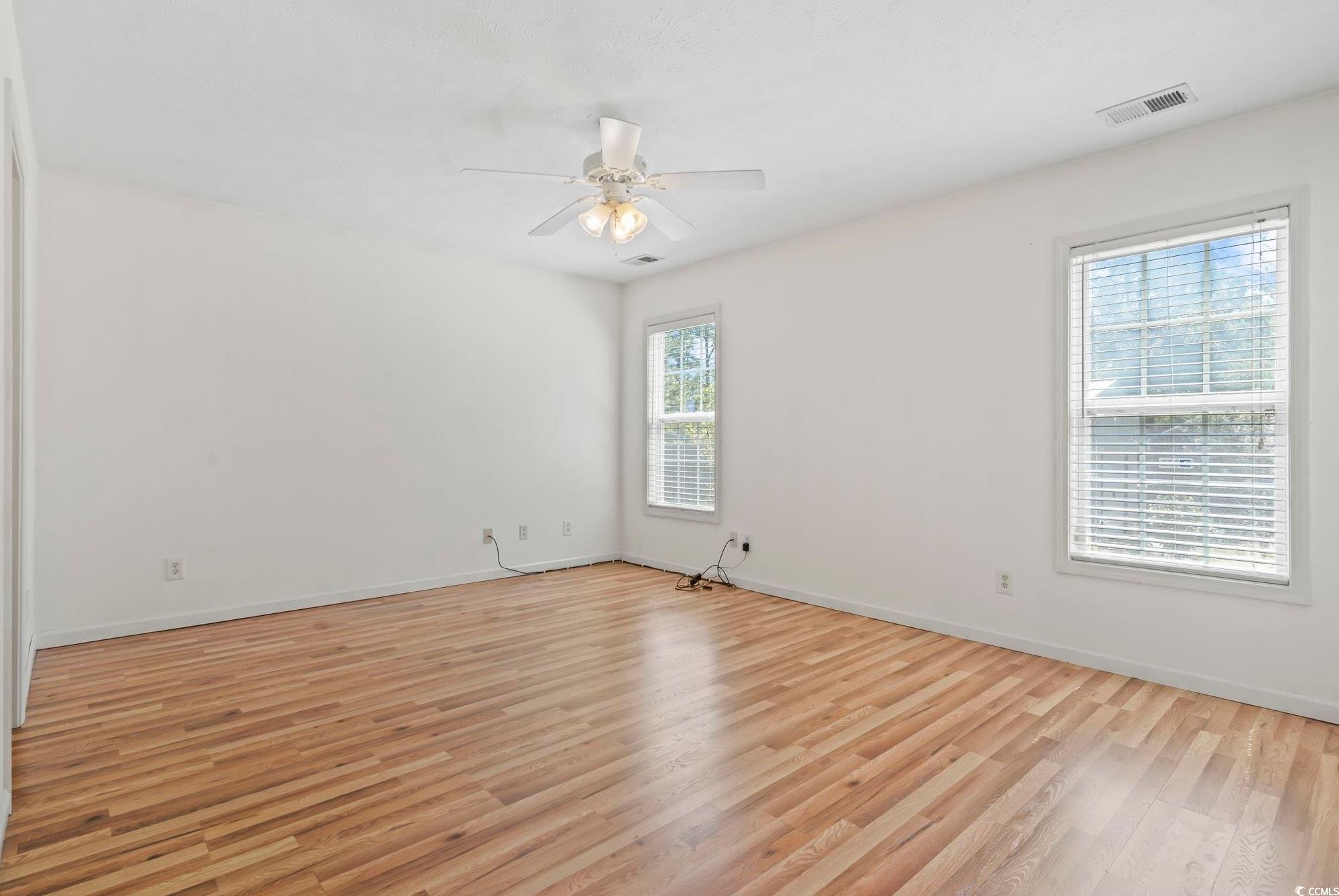 717 West Perry Road Myrtle Beach, SC 29579 - Photo 12 of 29 Owner's bedroom with light wood-style floors and a ceiling fan