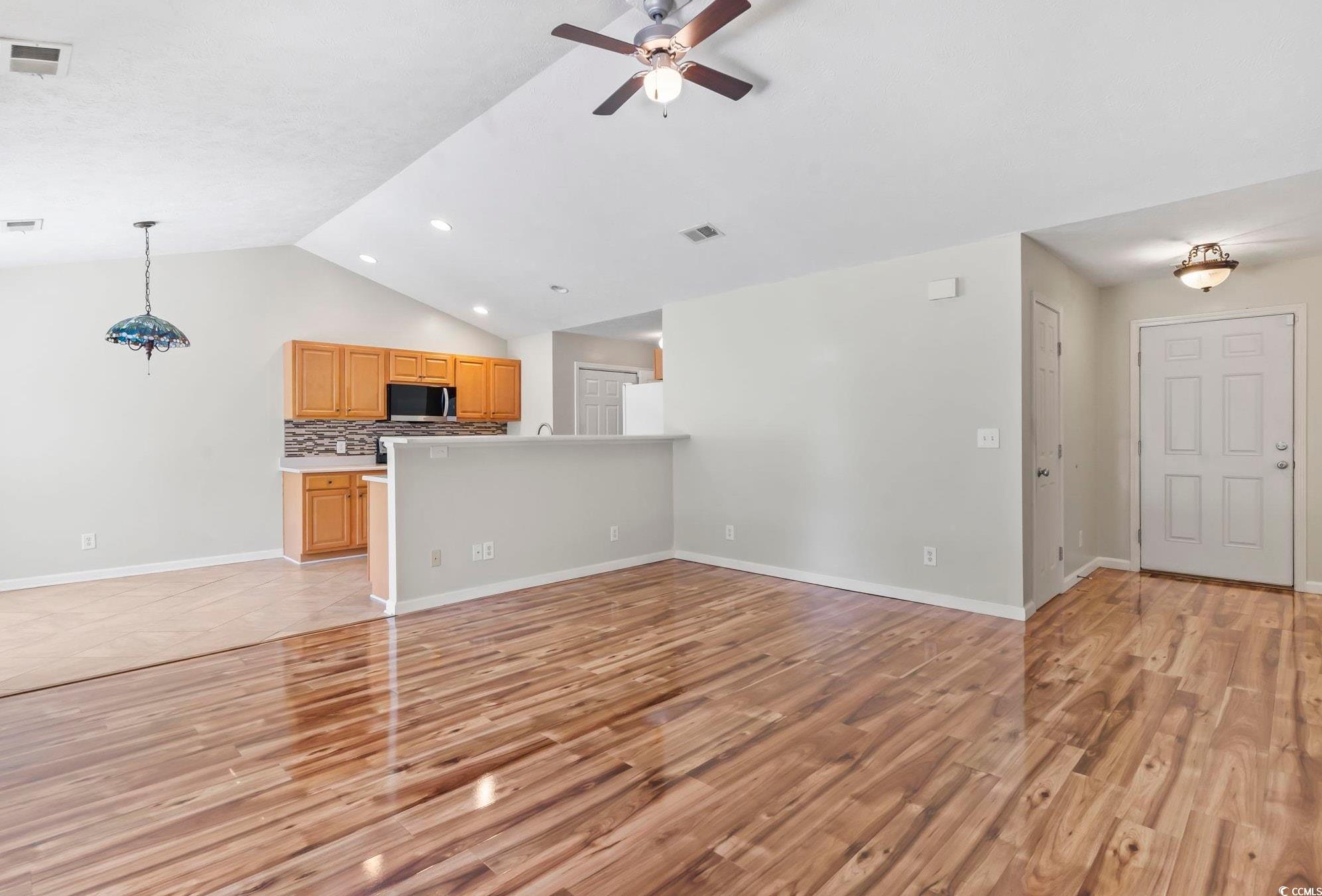 717 West Perry Road Myrtle Beach, SC 29579 - Photo 3 of 29 Unfurnished living room featuring vaulted ceiling, light wood-style flooring, a ceiling fan, and recessed lighting