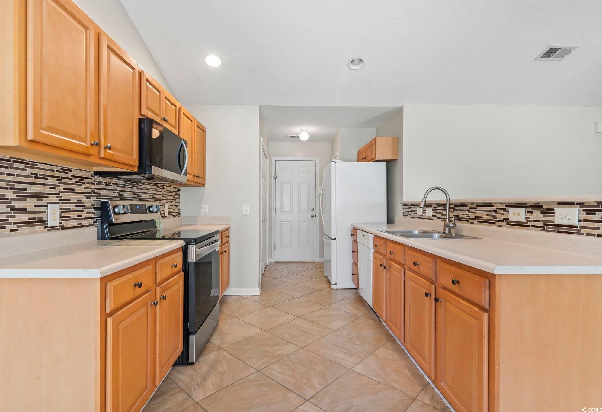 717 West Perry Road Myrtle Beach, SC 29579 - Photo 6 of 29 Kitchen featuring tasteful backsplash, stainless steel electric range oven, light tile patterned floors, light countertops, and recessed lighting
