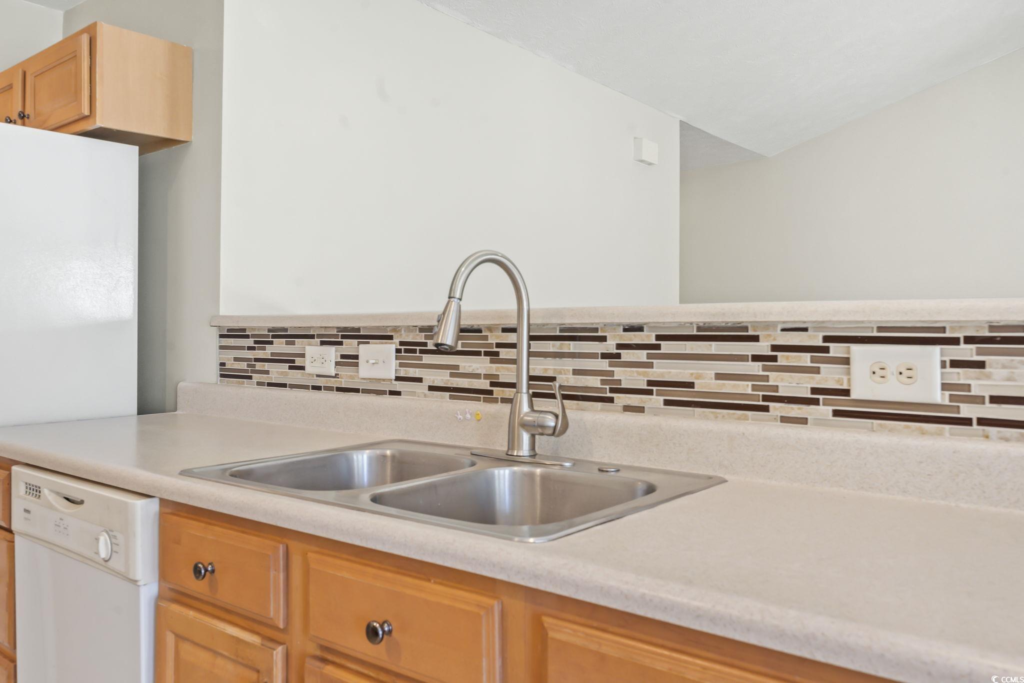 717 West Perry Road Myrtle Beach, SC 29579 - Photo 7 of 29 Kitchen with light countertops, white appliances, light brown cabinets, and tasteful backsplash