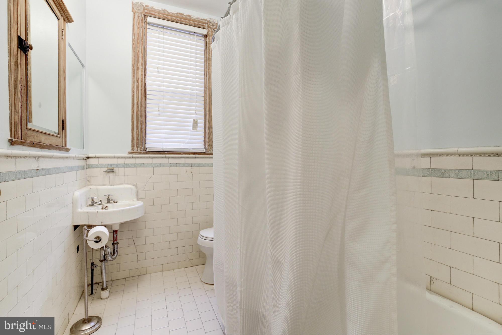 30 R Street Northeast Washington, DC 20002 - Photo 22 of 30 a bathroom with a sink toilet and shower