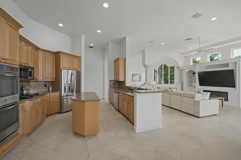 a large kitchen with a large counter top appliances and cabinets