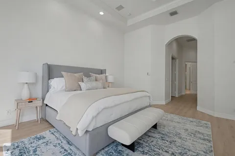 a bedroom with a bed and a lamp