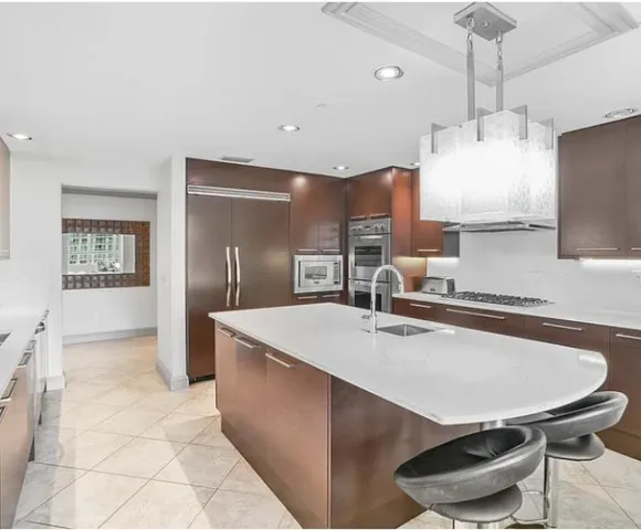 a kitchen with stainless steel appliances a sink stove and refrigerator