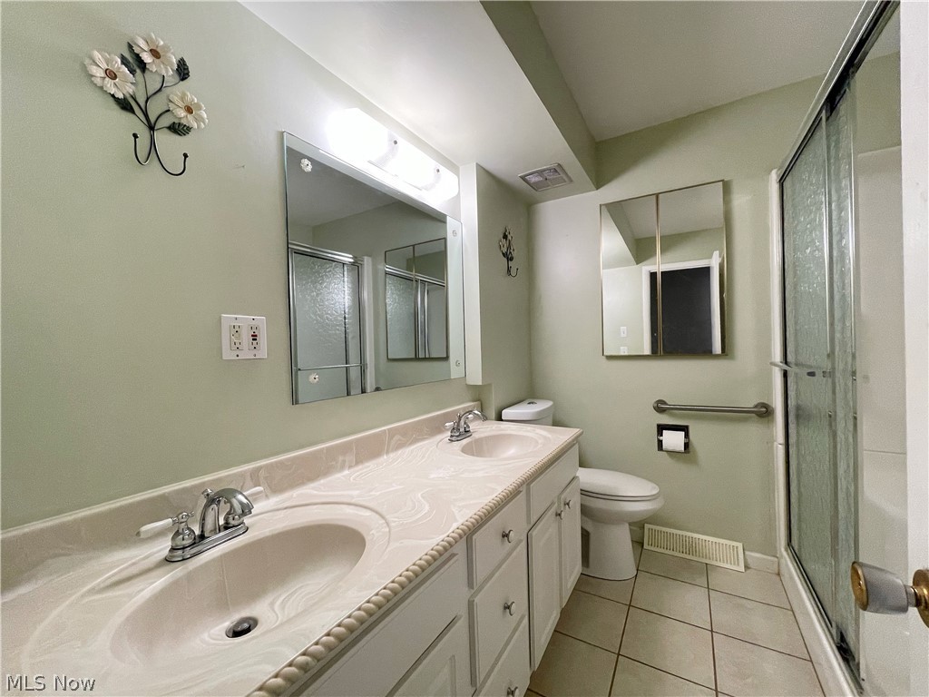 686 Shook Road Akron, OH 44319 - Photo 10 of 22 Lovely main bath with double vanity with integrated sinks, an alcove shower stall and a decorative chrome fixtures.