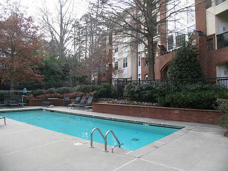 3636 Habersham Road Northwest, Unit 2308 Atlanta, GA 30305 - Photo 36 of 42 a view of backyard with swimming pool and seating space