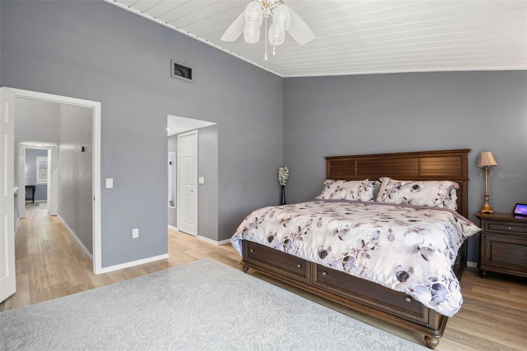 529 Sandy Hook Road Treasure Island, FL 33706 - Photo 25 of 55 a bedroom with a bed and a chandelier