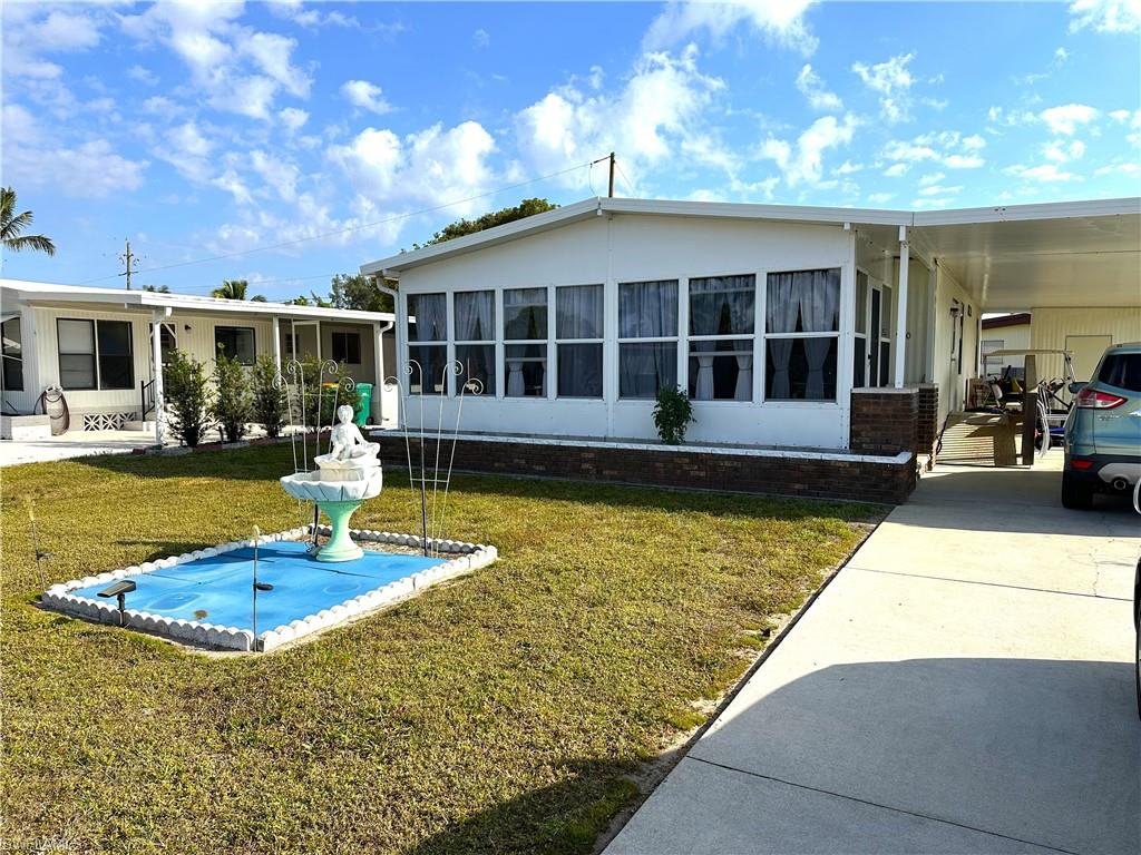 a view of a house with swimming pool and sitting area
