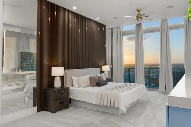 a bedroom with a large bed and a large window