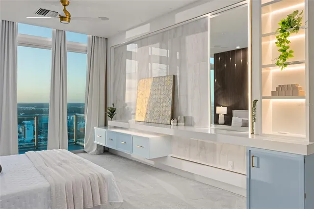 a large bedroom with a large window and a bed