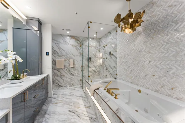 a bathroom with a tub sink and mirror