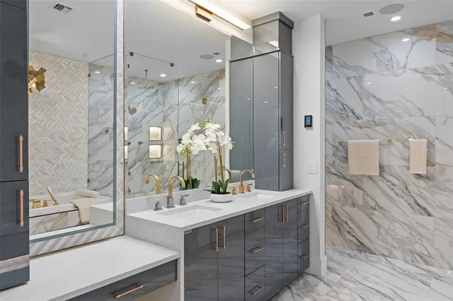 a bathroom with a double vanity sink mirror and shower