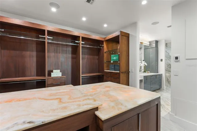 a bathroom with a granite countertop sink a large mirror and shower
