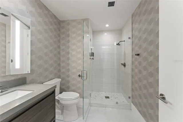 a view of a room with a bed and glass window