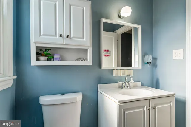 a bathroom with a toilet sink and mirror