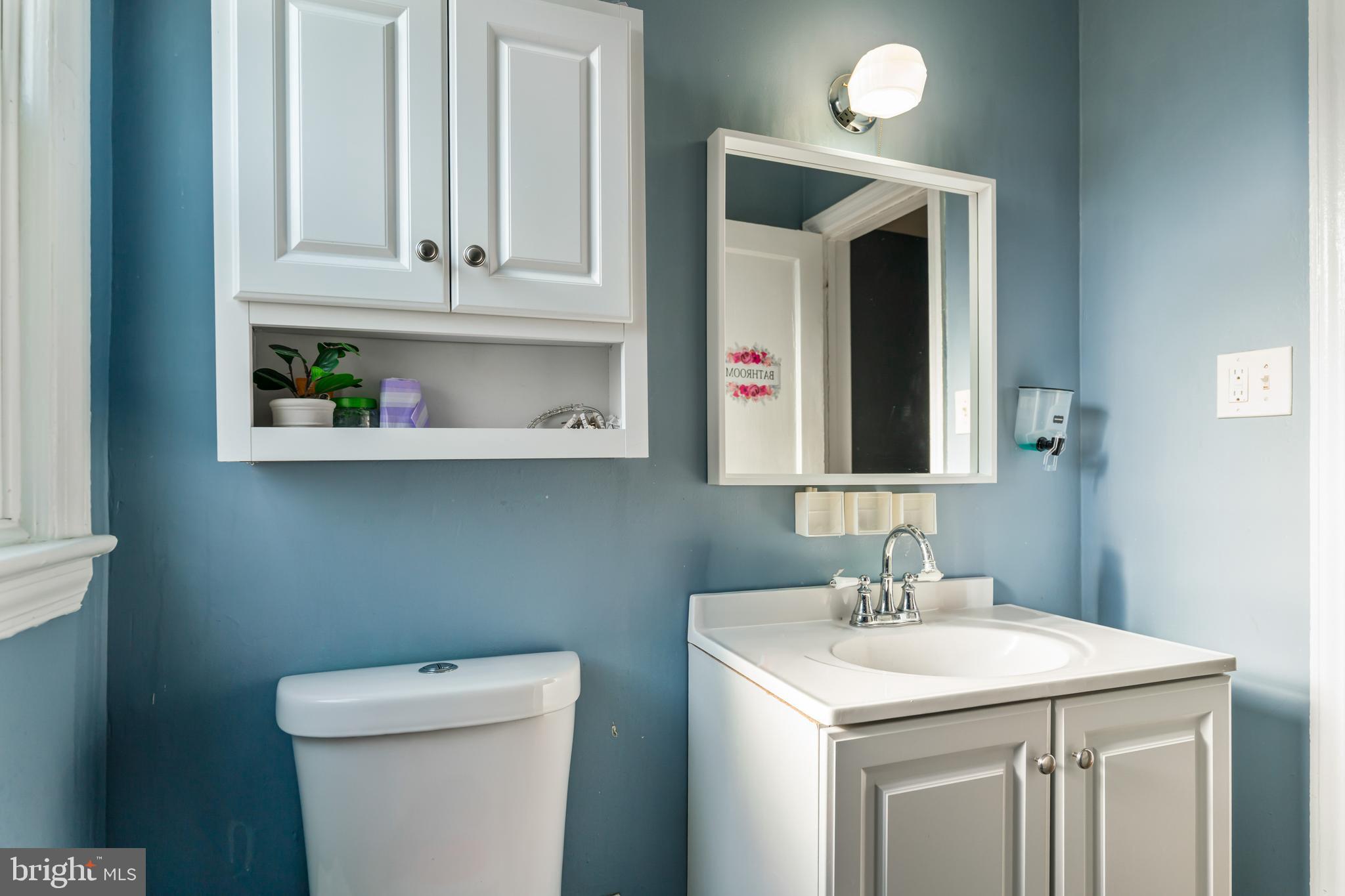 4801 B Street Southeast Washington, DC 20019 - Photo 15 of 43 a bathroom with a toilet sink and mirror