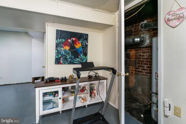 a living room with a couch and a chandelier