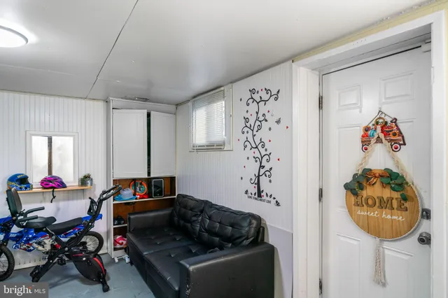 a view of a brick house with many windows next to a yard