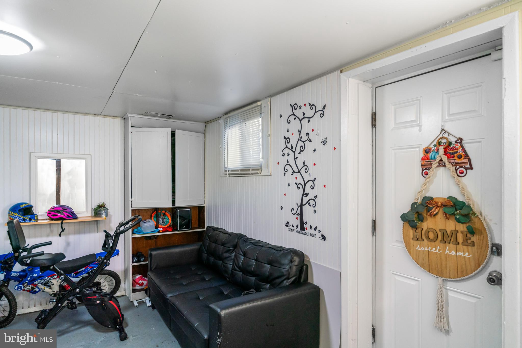 4801 B Street Southeast Washington, DC 20019 - Photo 34 of 43 a living room with a couch and a chandelier