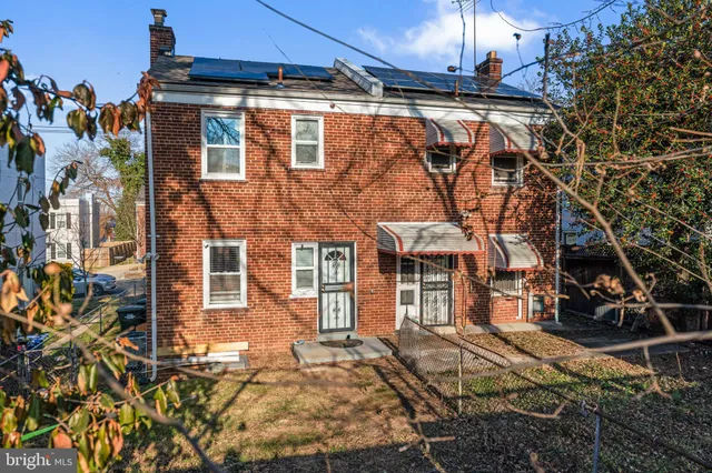 a view of a brick house with many windows