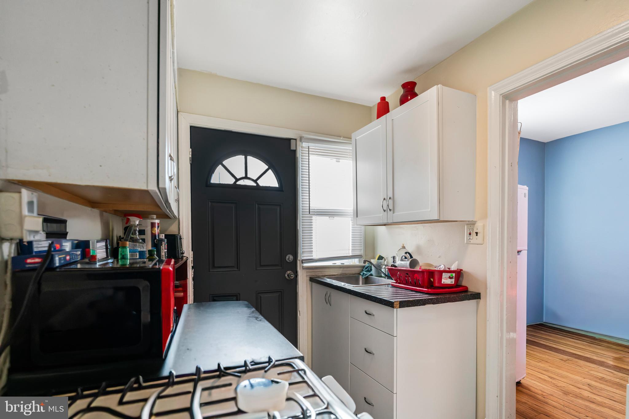 4801 B Street Southeast Washington, DC 20019 - Photo 9 of 43 a kitchen that has a sink cabinets and wooden floor