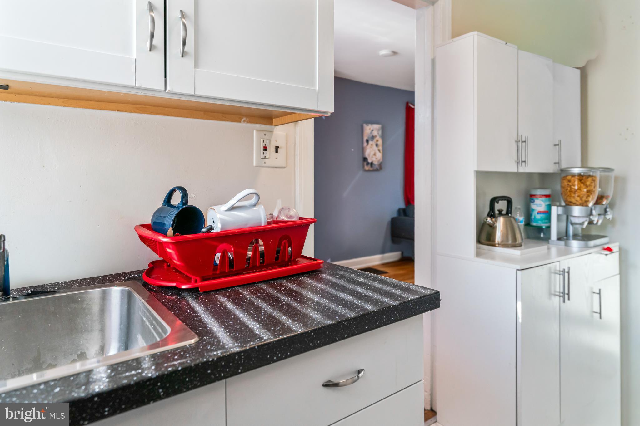 4801 B Street Southeast Washington, DC 20019 - Photo 10 of 43 a kitchen with stainless steel appliances granite countertop a stove and white cabinets