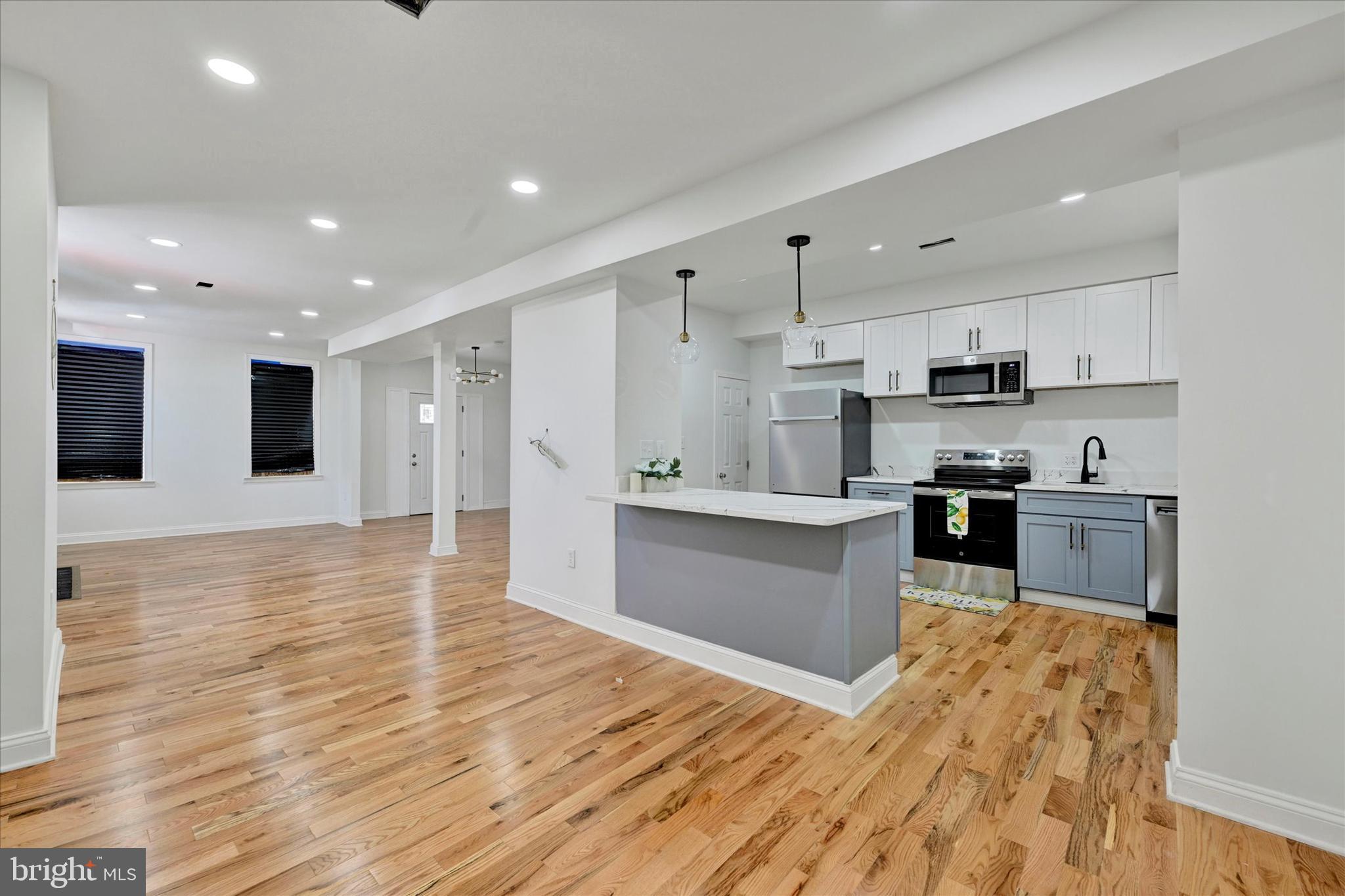 2400 West Lafayette Avenue Baltimore, MD 21216 - Photo 11 of 33 a large kitchen with stainless steel appliances granite countertop a large counter top and a stove
