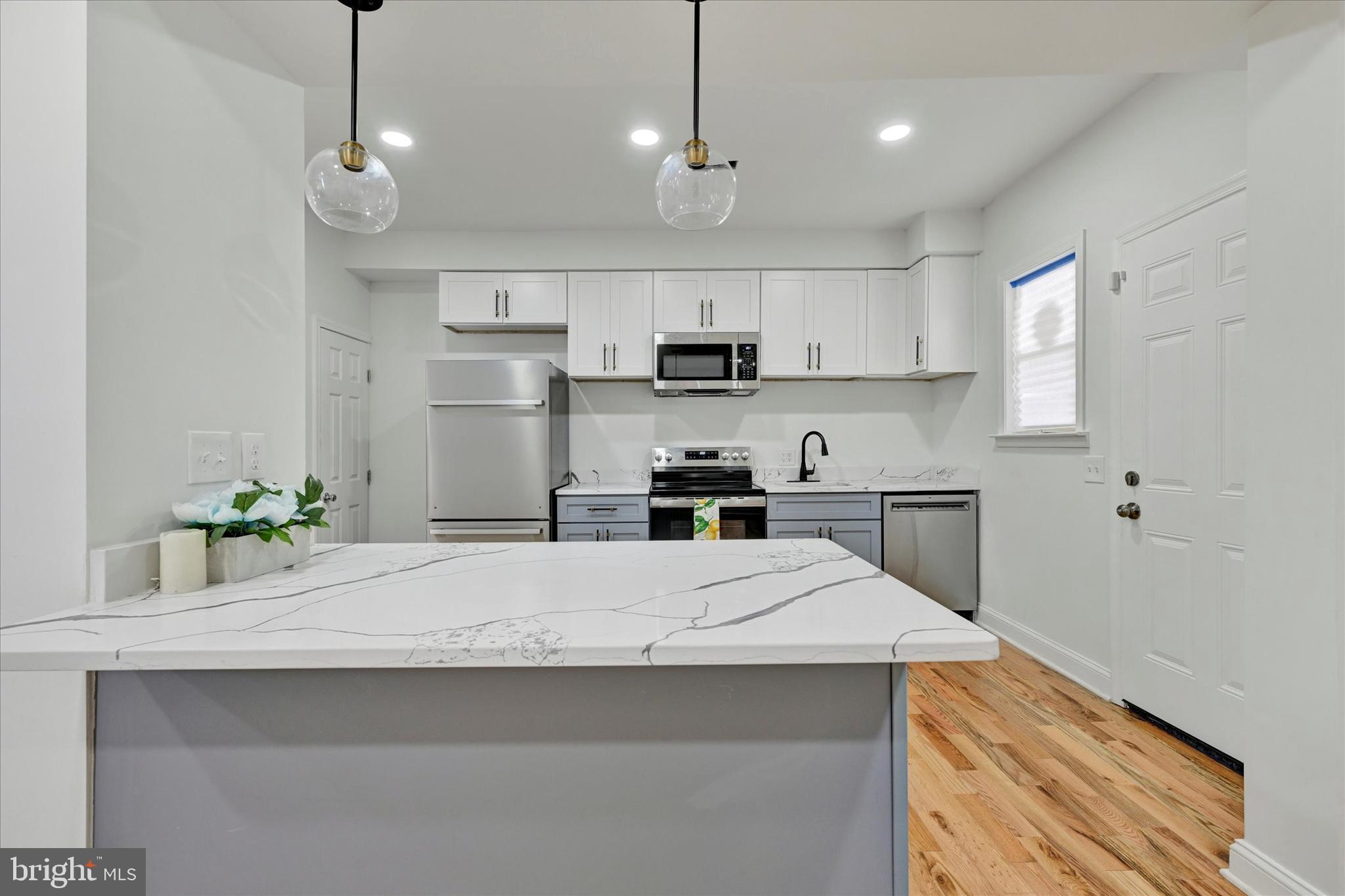 2400 West Lafayette Avenue Baltimore, MD 21216 - Photo 12 of 33 a kitchen with kitchen island a sink stainless steel appliances and cabinets
