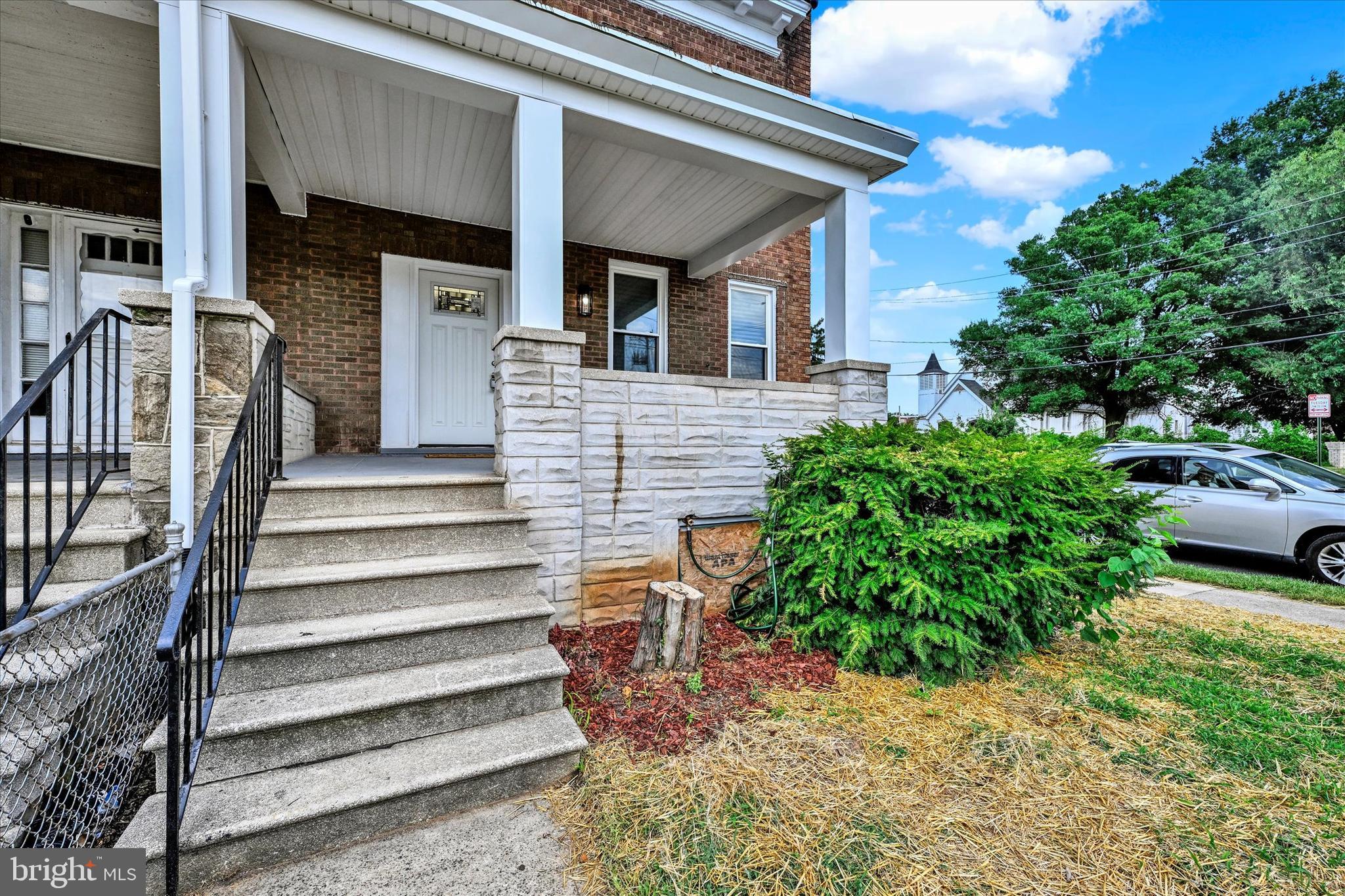 2400 West Lafayette Avenue Baltimore, MD 21216 - Photo 2 of 33 a front view of a house with a garden