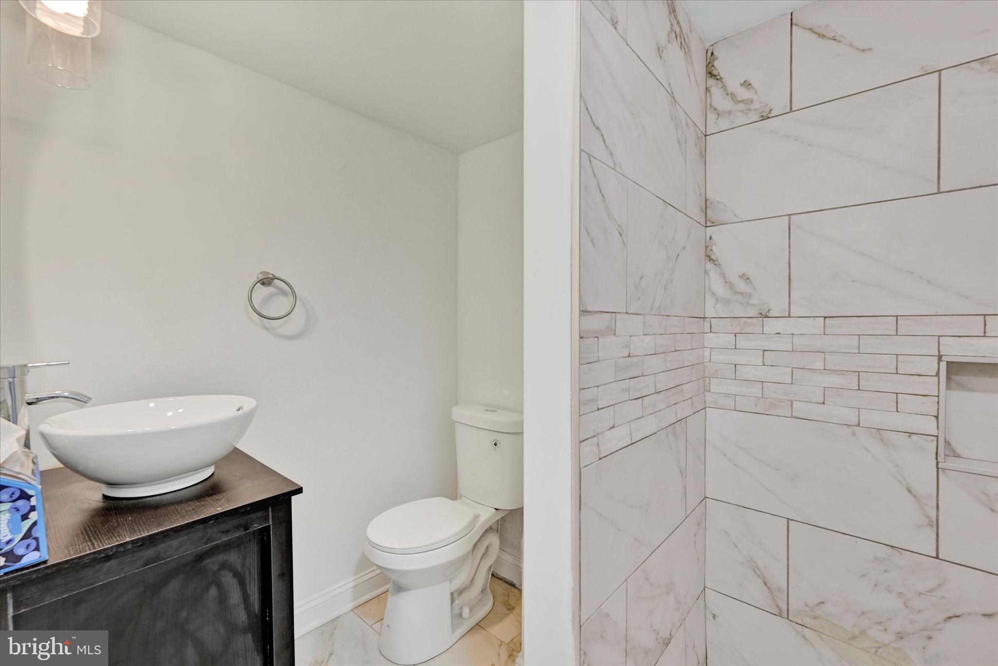 2400 West Lafayette Avenue Baltimore, MD 21216 - Photo 26 of 33 a bathroom with a granite countertop toilet and a sink