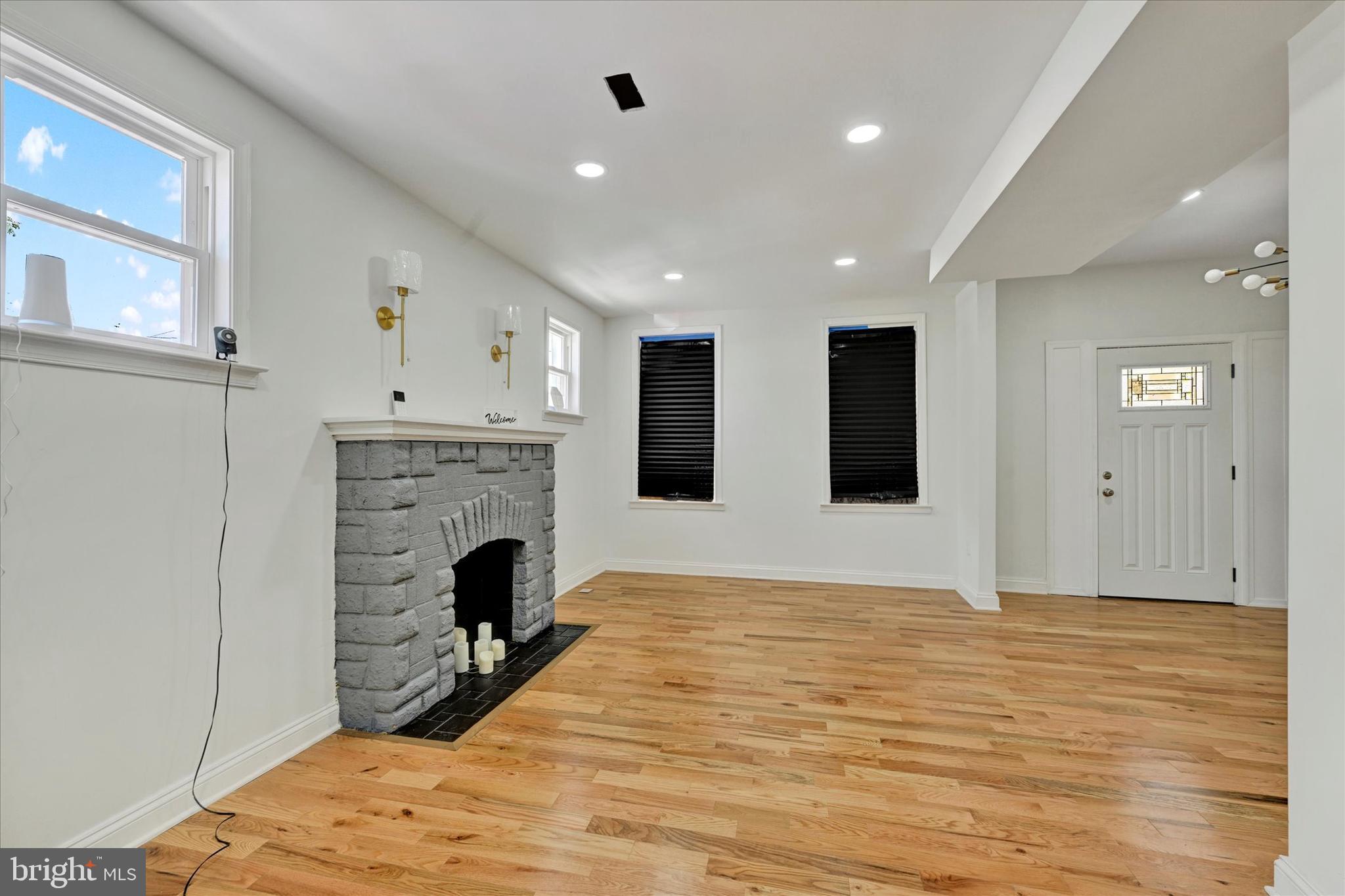 2400 West Lafayette Avenue Baltimore, MD 21216 - Photo 8 of 33 a view of livingroom with fireplace and wooden floor