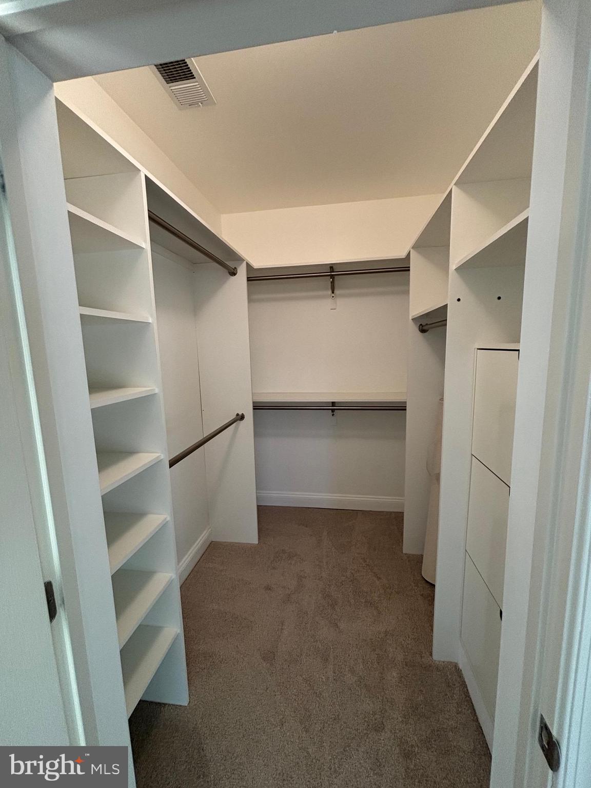 7300 Travertine Drive, Unit 302 Baltimore, MD 21209 - Photo 13 of 19 a view of walk in closet with empty racks