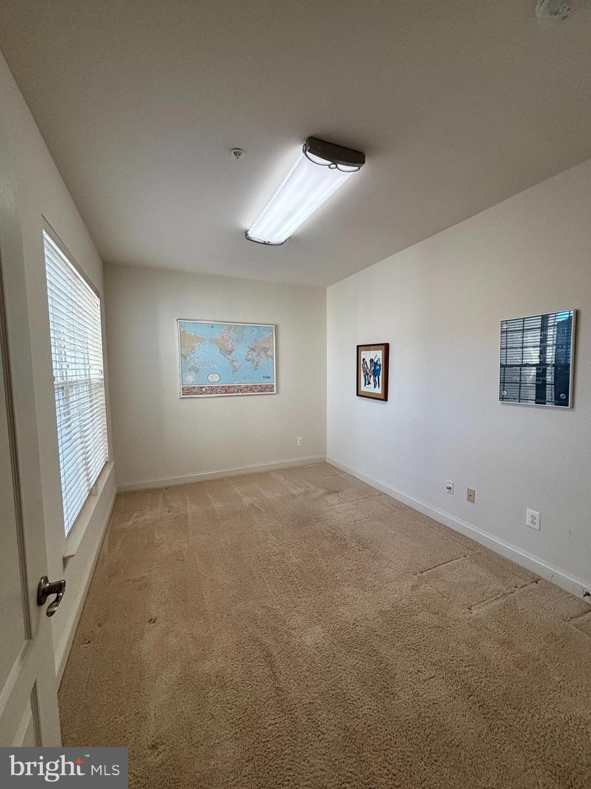 7300 Travertine Drive, Unit 302 Baltimore, MD 21209 - Photo 16 of 19 a view of a big room with windows and chandelier fan