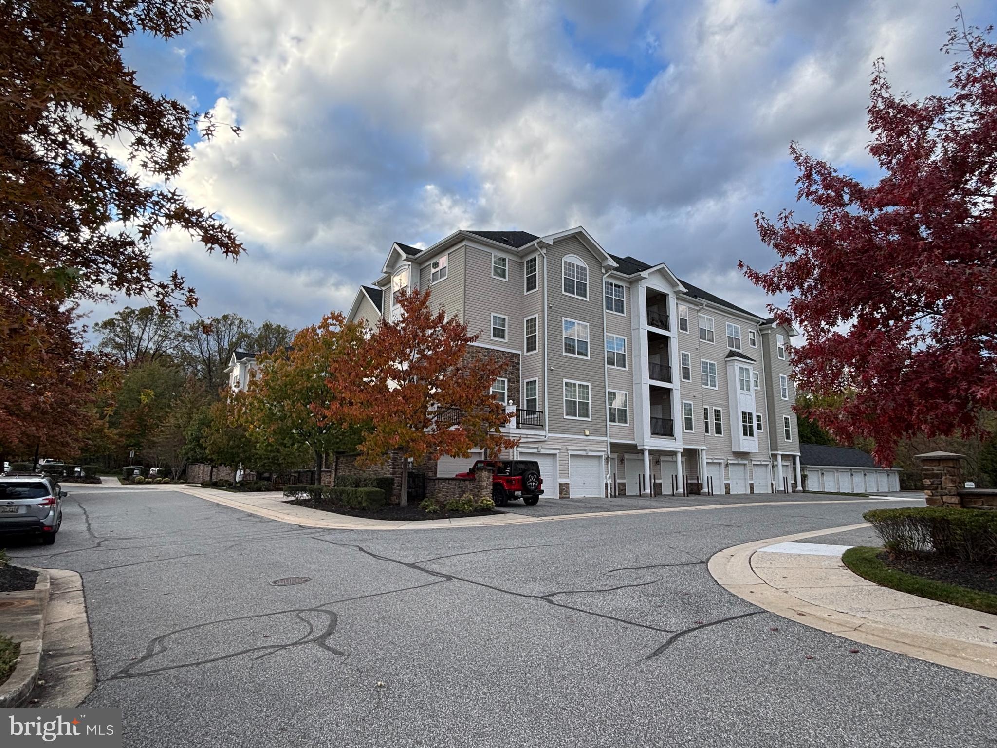 7300 Travertine Drive, Unit 302 Baltimore, MD 21209 - Photo 2 of 19 a front view of a building with trees